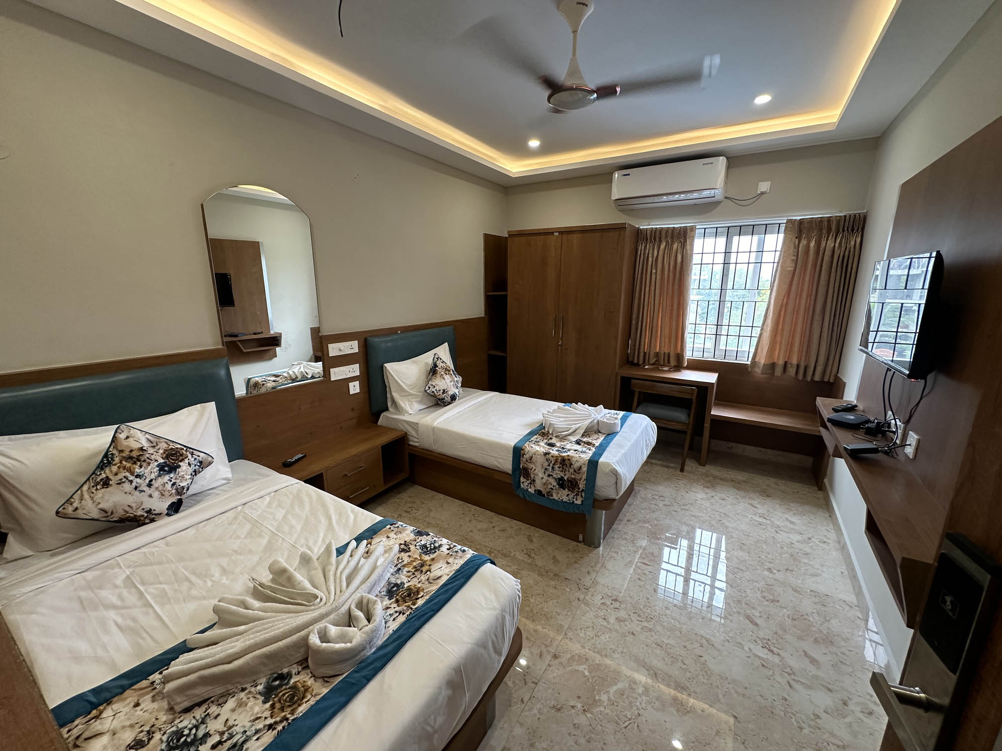 Twin Room with two comfortable beds and modern amenities at Plaza Tower Hotel Tirupati